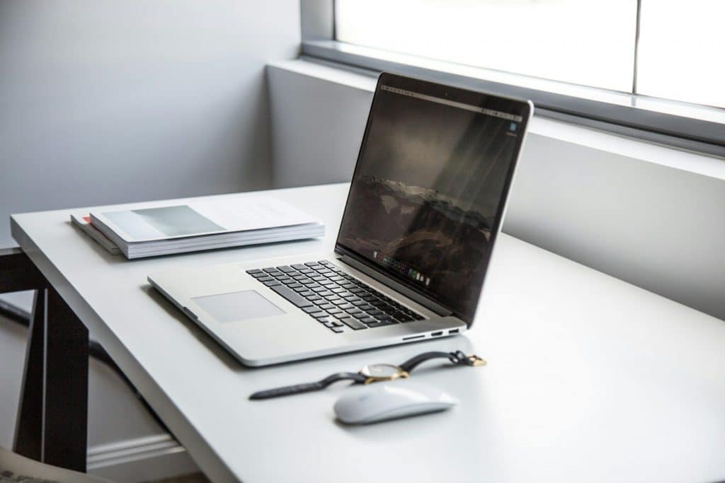 Laptop and notes on a professional desk, representing resume writing and career strategy